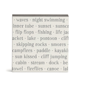 A white square wall art with words about the lake on it.