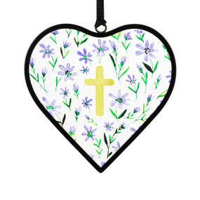 A small heart shaped sun catcher with an illustration of a yellow cross and small purple flowers.