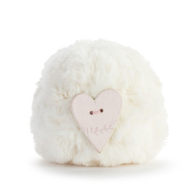 A round cream pouf with a heart shaped diffuser attached.