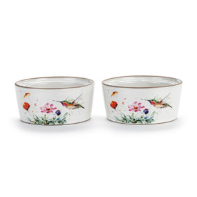 Two white ceramic ramekins with a watercolor image of a hummingbird and flowers, displayed at a slight angle to show the inner rim for stacking.