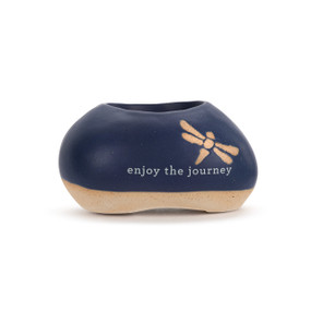 A mini dark blue and tan ceramic planter. It has a butterfly and the saying "enjoy the journey".