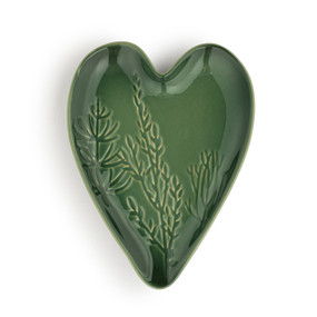 A dark green heart shaped ceramic spoon rest with a leaf pattern on it.