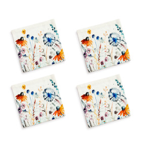 A set of four white cocktail napkins with illustrated meadow flowers.