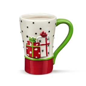 A white ceramic mug with black dots and a green handle. There are two raised red and white presents on the front.