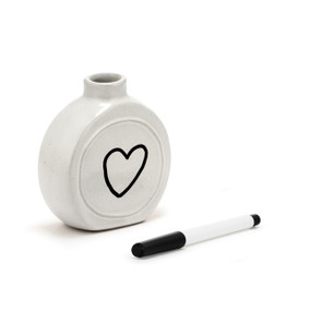 A small white ceramic round vase with space to write a message. The vase comes with a black write on marker, displayed angled to the right with a heart drawn on the front.