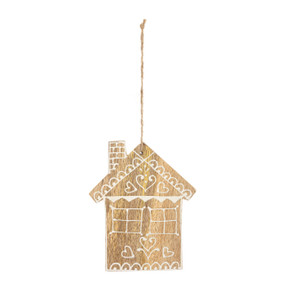 A house shaped wood ornament painted white in a Scandinavian style.