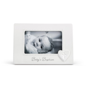 A white ceramic 4x6 frame with a raised white heart with a cross in the middle at the lower right corner. The frame says "Baby's Baptism".