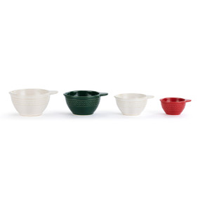 A set of four ceramic measuring cups in white, green and red with decoration around the outside.