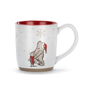 A white ceramic mug with a red interior and tan textured base. There is an image of Pooh and Piglet standing in the snow on the front.