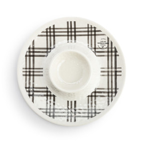 Top down view of a round chip and dip plate with a black plaid pattern.