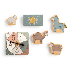 A Nativity journey game with wood animal pieces, a spinner and card deck.
