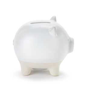 A white ceramic piggy bank. The feet of the bank are cream and textured.