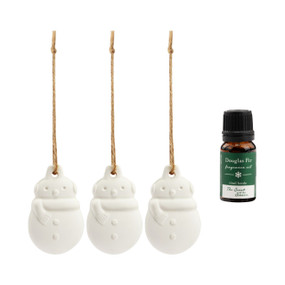A set of three hanging white ceramic diffusers shaped like snowmen that come with a small bottle of Douglas Fir fragrance oil.