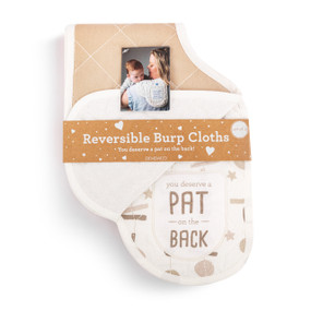 A set of two burp cloths in brown and white. One is light brown and the other has a hanging mobile illustration and says "you deserve a Pat on the Back", displayed in a packaging band.