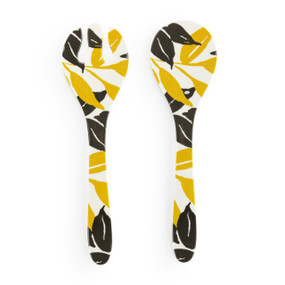 A large white plastic set of two serving utensils with a dark yellow and gray leaf pattern.