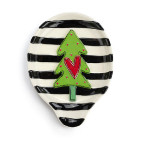 A black and white striped stoneware spoon rest with a raised green tree and red heart.
