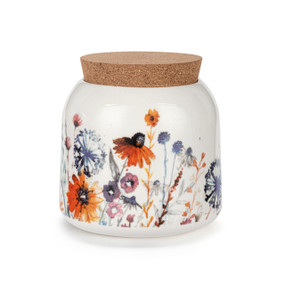 A small sized white ceramic container with a cork lid. The container has illustrated meadow flowers.
