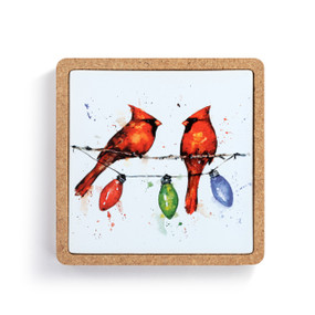 A square ceramic trivet in a cork base. The tile has a watercolor image of two cardinals on a string of holiday lights.