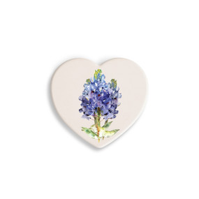 A set of four heart shaped white ceramic coasters with a watercolor image of a bluebonnet.