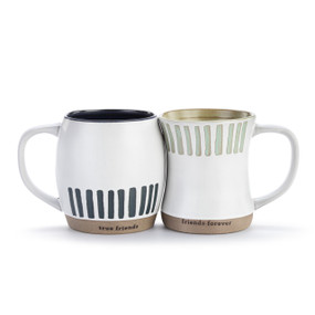 A set of two white mugs with tan textured bases. One says, "true friends" and has brown vertical stripes on the bottom half of the mug. The other mug says, "friends forever" and has light green vertical stripes on the top half of the mug.