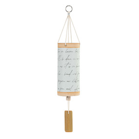 A white tubular ceramic wind chime with a wood chime, peach color at the top and bottom and handwritten script around the outside.