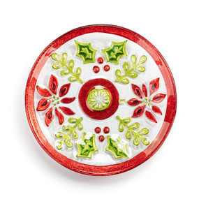 A mini round glass plate with the image of Christmas florals surrounding a Christmas ornament.