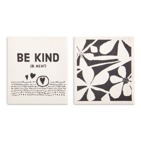 Two black and white biodegradable dish cloths, one with a large floral pattern and the other says "Be Kind (& Neat)".