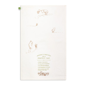 A cream kitchen towel with illustrations of Pooh and Piglet and Pooh's recipe for a perfect day, displayed with the towel laid out flat.