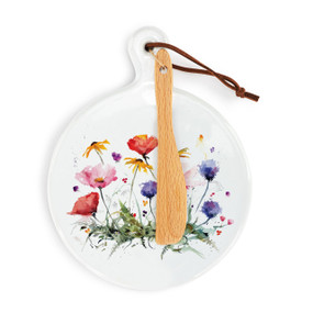 A round ceramic white mini serving board with watercolor wildflowers. The board has a small wood knife attached.