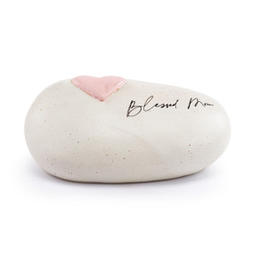 A white stoneware rock with a raised pink heart and "Blessed Mom" on the top.