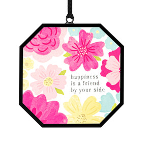 A small octagon shaped sun catcher with illustrated large pink flowers and the saying "happiness is a friend by your side".
