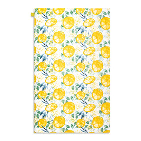 A white kitchen towel with illustrations of yellow lemons displayed with the towel laid out flat.