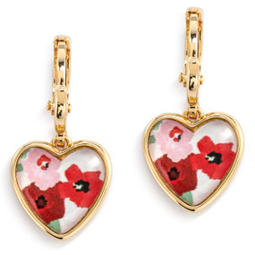 A pair of gold dangling earrings with a heart shaped charm and an illustration of red and pink flowers inside.