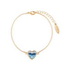 An adjustable gold chain bracelet with a heart shaped charm with an image of a blue butterfly inside.