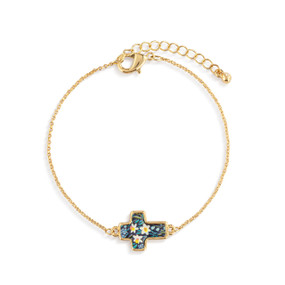 A gold chain adjustable bracelet with a cross shaped charm illustrated with flowers and has the word "Blessed" on the back.