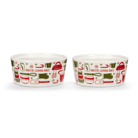 Two white ceramic ramekins that say "Bakers Gonna Bake" with red and green baking utensils on the outside, displayed at an angle to show the lip on the inside rim allowing them to stack.