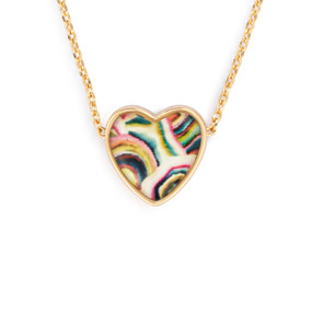 Detail view of the charm on an adjustable gold chain necklace with a heart shaped charm of colorful lines.