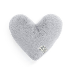 A gray heart shaped weighted pillow with a fabric tag that says "kindness".