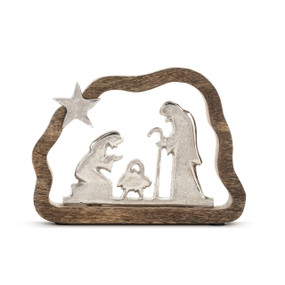 A silver metal silhouette of the Holy Family and the star, framed in an open wood carved and curved frame.