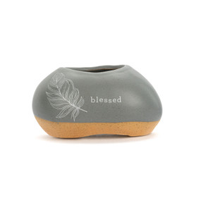 A mini gray and tan ceramic planter. It has an illustration of a feather and the word "Blessed" on the front.