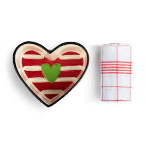 A small heart shaped ceramic pan with a red and cream striped interior and a green heart. The pan comes with a white towel with red stripes.