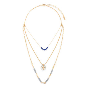 An adjustable gold chain necklace with three layers including blue and gray beads and a round silver charm with a gold cross.