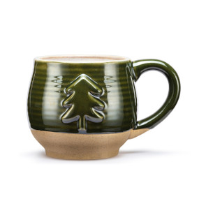 A green ceramic mug with a tan textured base and cream interior. The mug has a raised tree on the front.