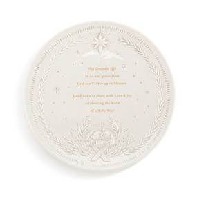 A cream ceramic decorative plate with an image of Baby Jesus at the bottom and the star of Bethlehem at the top. There is an inspirational saying about The Greatest Gift in the middle.