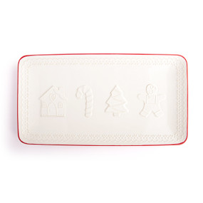 A rectangular white platter with a decorative edge and red rim. There are images of a gingerbread house, candy cane, tree and gingerbread man on the platter.