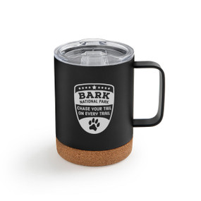 Black stainless steel handled mug with a cork base and clear plastic lid. The mug has the saying "Bark national park. Chase your tail on every trail".
