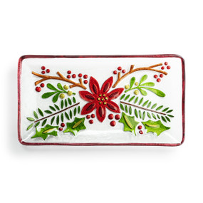 A rectangular glass platter with a red and green poinsettia flower.