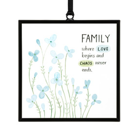 A small square shaped sun catcher with small blue flowers and the saying "Family where Love begins and Chaos never ends".