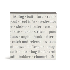 A white square wall art with words about fishing on it.