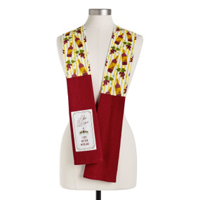 A yellow wine themed fabric kitchen boa with red towel ends and a fabric patch with the saying "Like Wine I Get Better With Age", displayed on a mannequin.